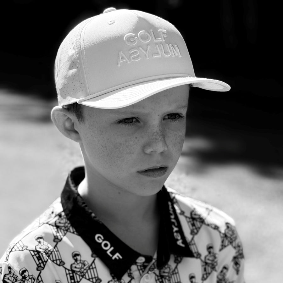 Junior golfer in a Golf Asylum cap