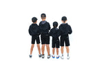 Four junior golfers seen from behind in black hoodies and black shorts
