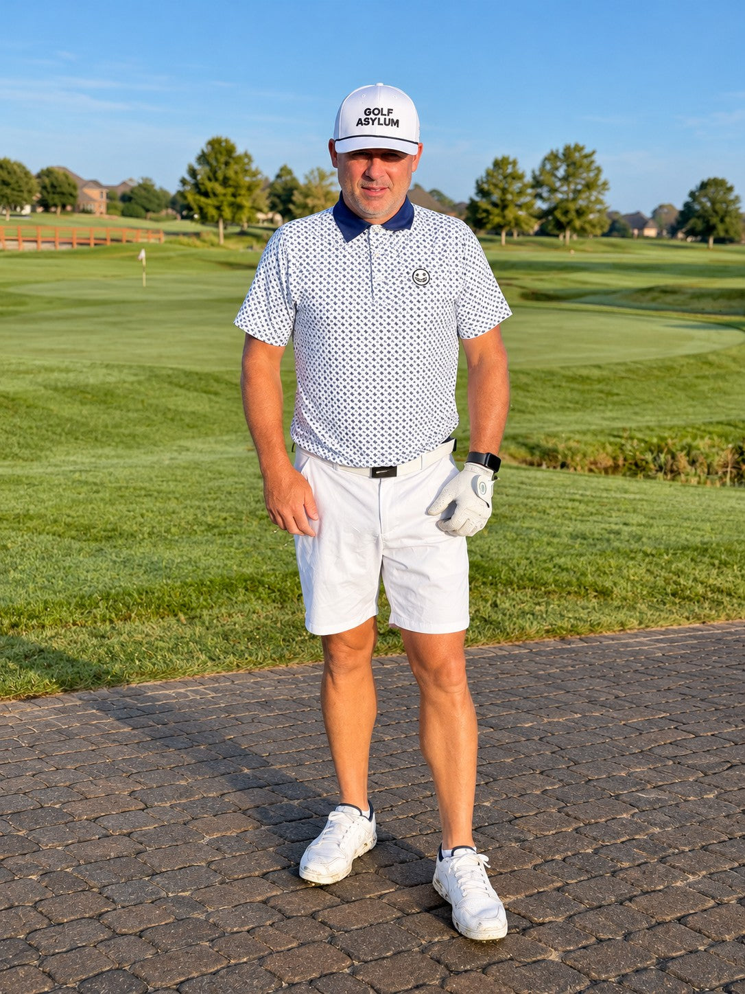 Adult golfer on a course in the electric blue and white Ballhead polo and a Golf Asylum cap