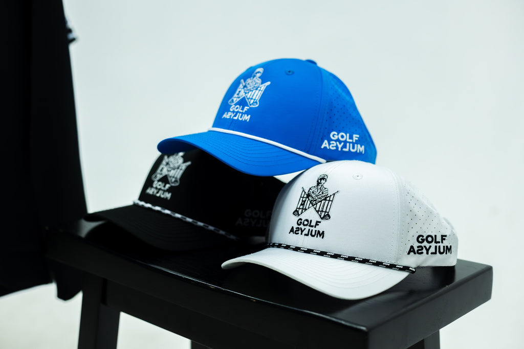 Blue, black and white Straight Jacket caps on a stool