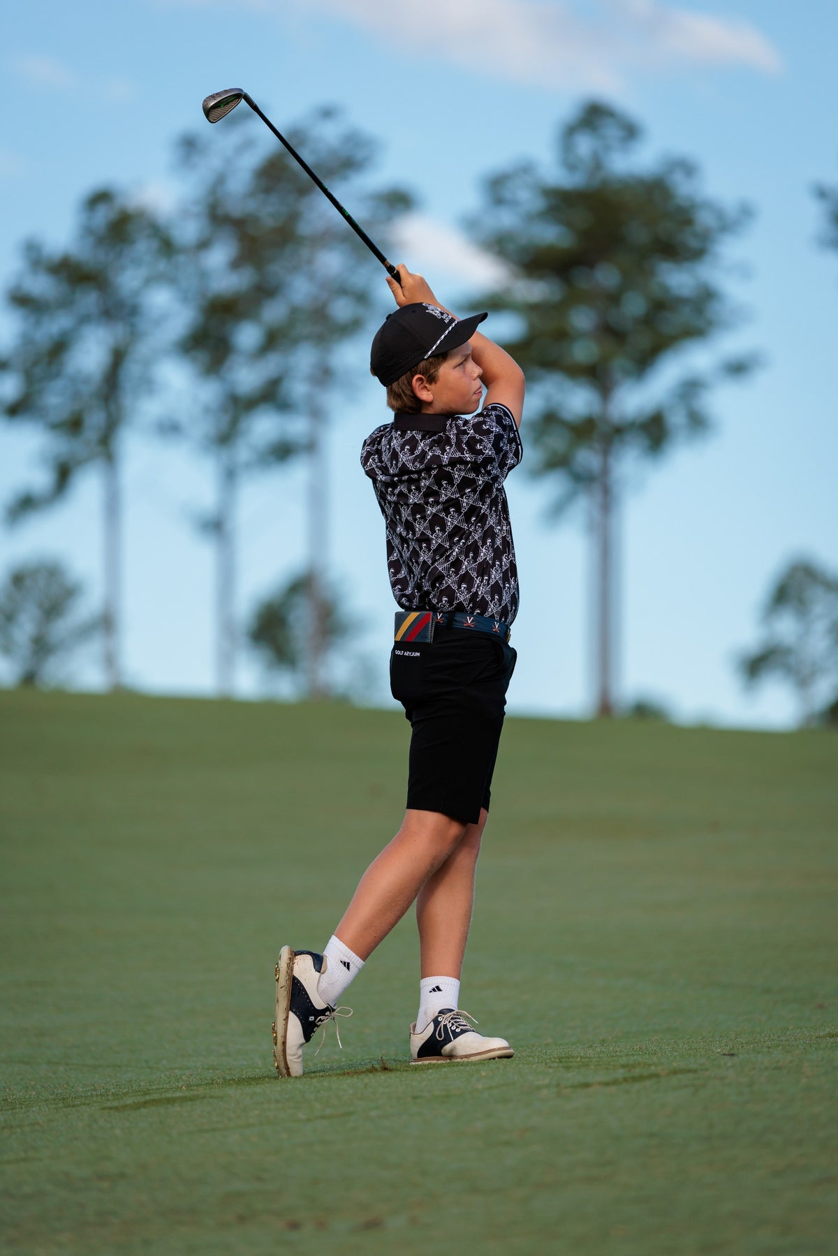 Junior golfer holding his finish after a tee shot at the Golf Asylum Invitational