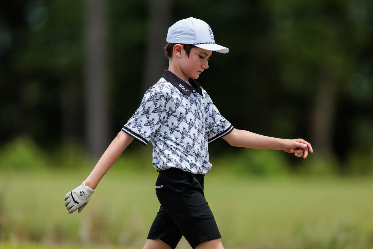 Junior golfer walking the course at the Golf Asylum Invitational