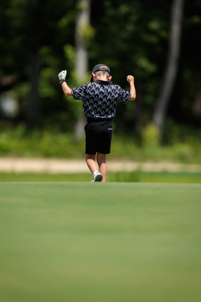 Junior golfer celebrating on the green at the Golf Asylum Invitational