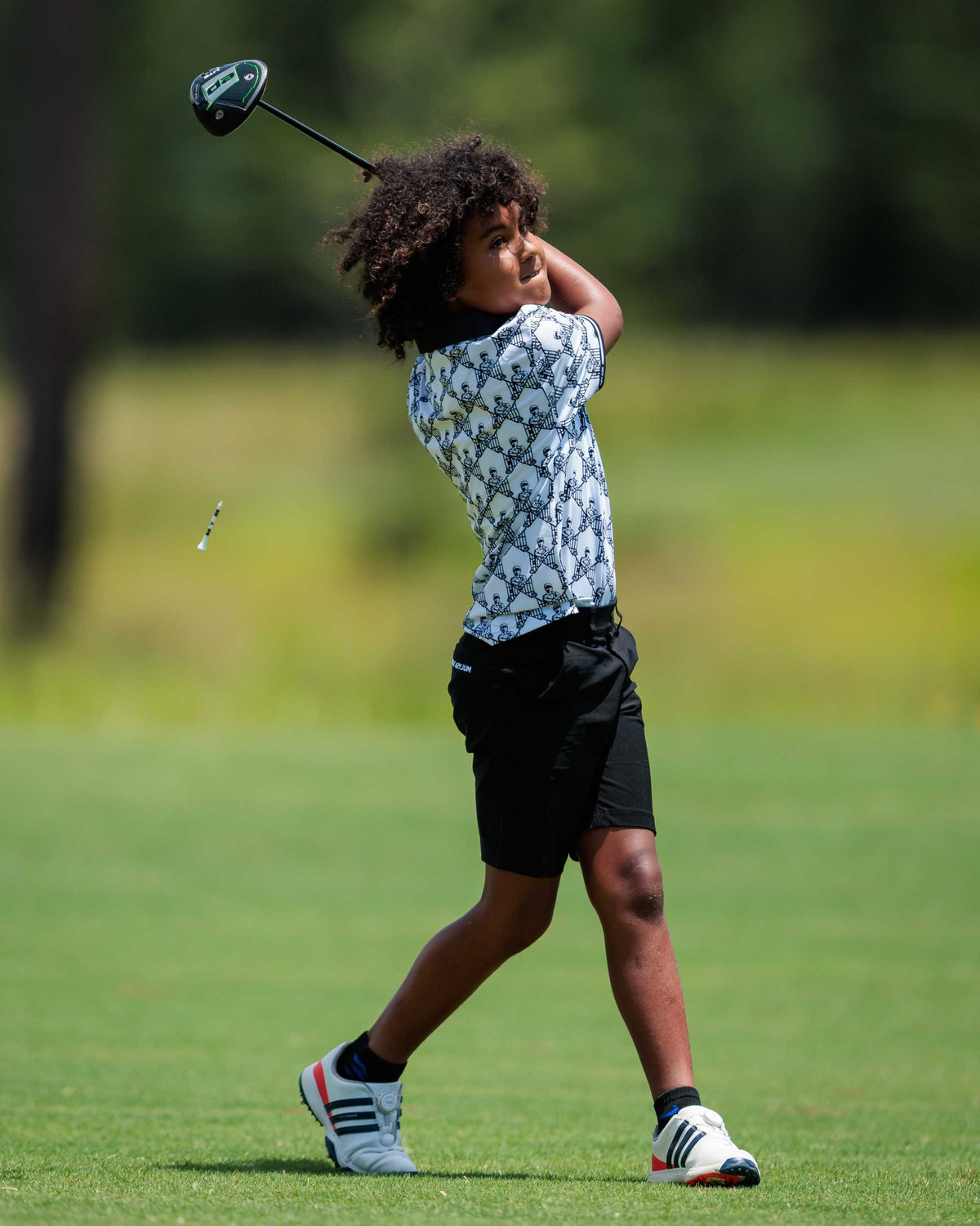 Junior golfer finishing a drive at the Golf Asylum Invitational