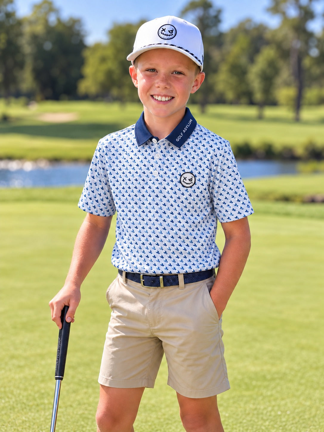 Junior golfer on a course in the electric blue and white Ballhead polo